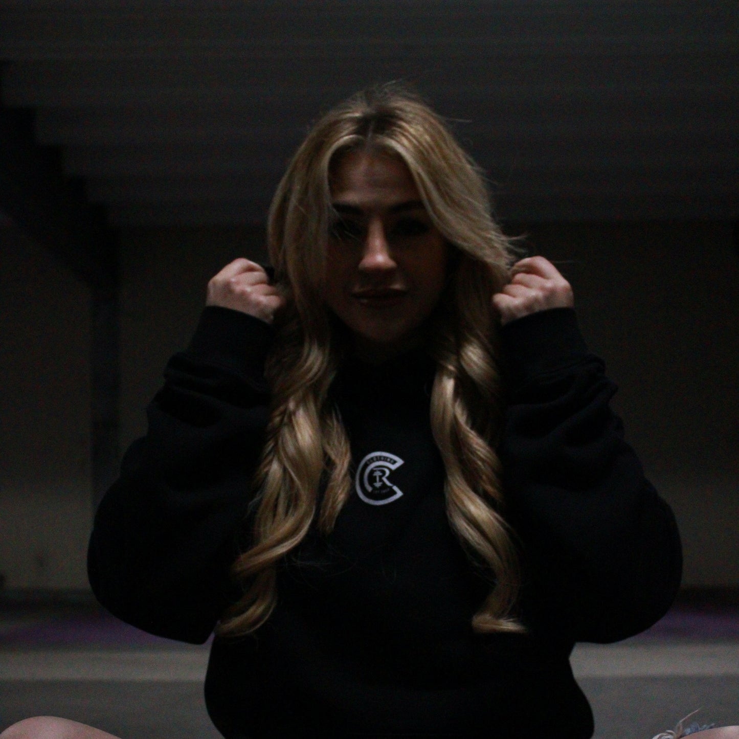 Chase Results clothing brand, based in Norfolk Norwich, features a confident blonde woman wearing the Empower Confidence hoodie. The hoodie, designed for both comfort and style, reflects strength and empowerment, making it the perfect choice for those looking to embrace their inner power