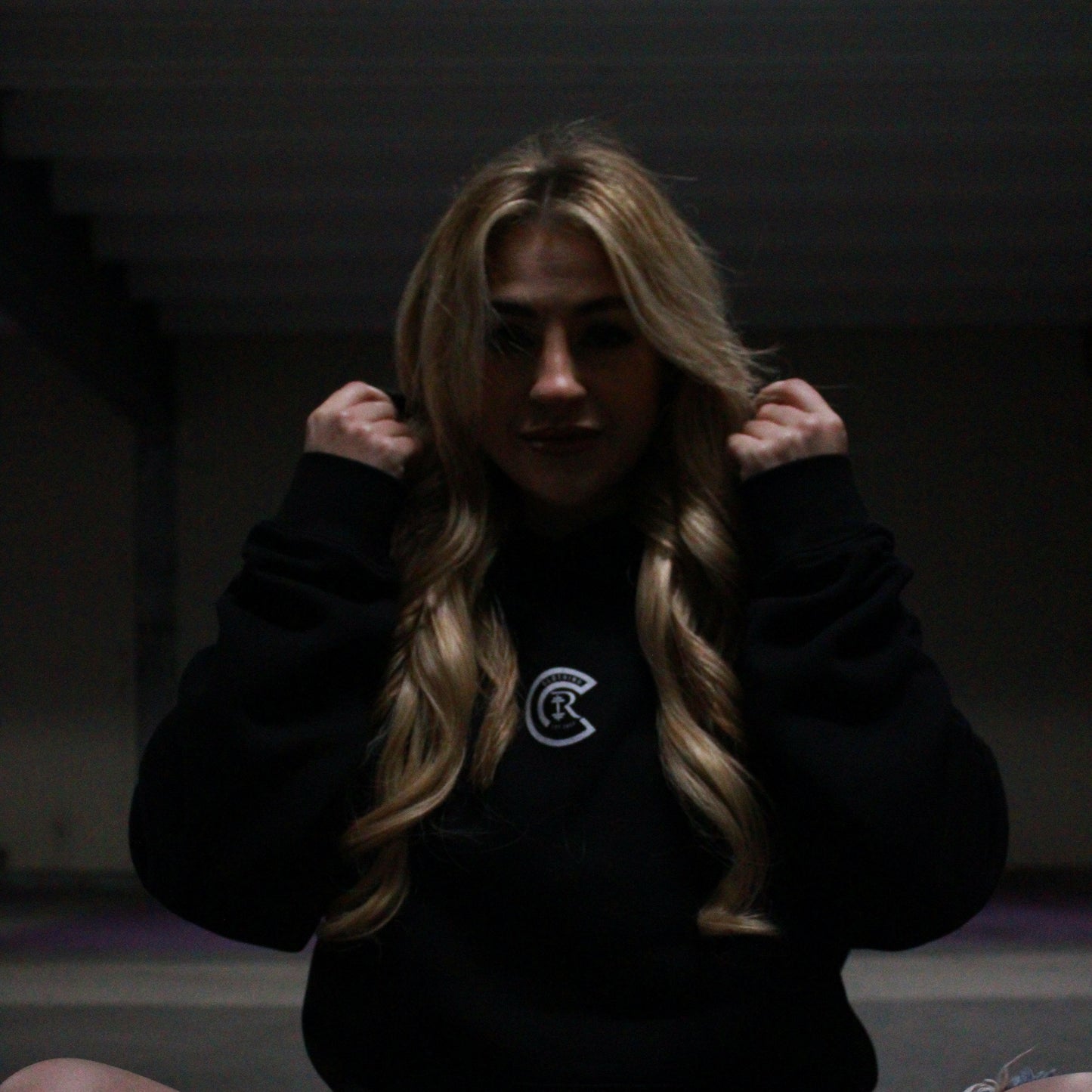 Chase Results clothing brand, based in Norfolk Norwich, features a confident blonde woman wearing the Empower Confidence hoodie. The hoodie, designed for both comfort and style, reflects strength and empowerment, making it the perfect choice for those looking to embrace their inner power